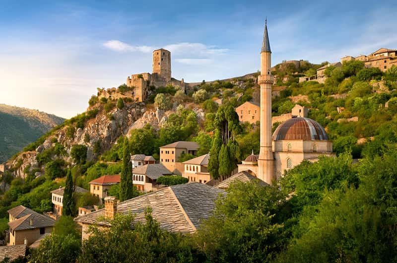 Počitelj fortress, mosque dome and minaret on a sunlit hillside, Bosnia and Herzegovina